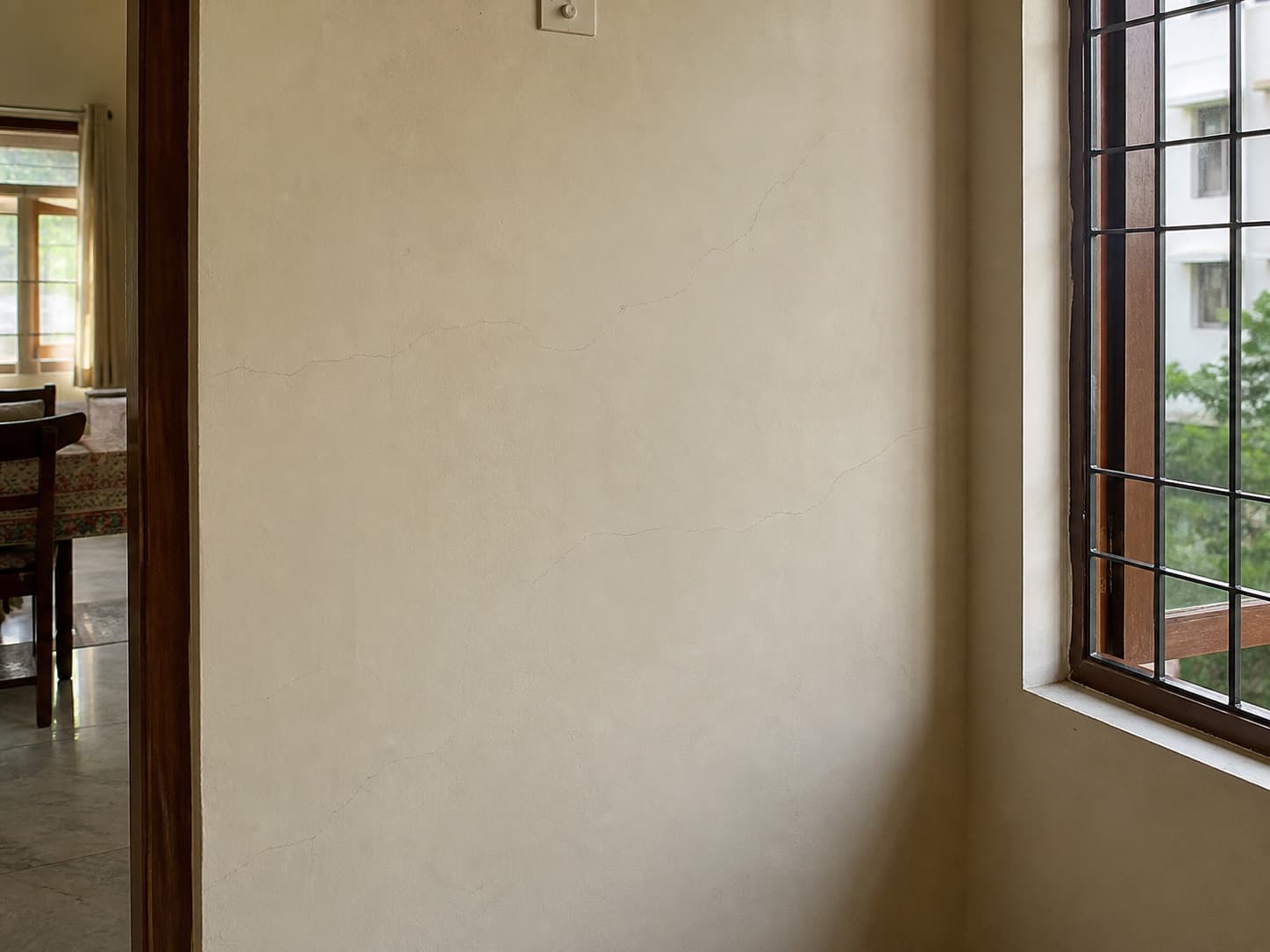 Close view of cracks running through a painted interior wall surface