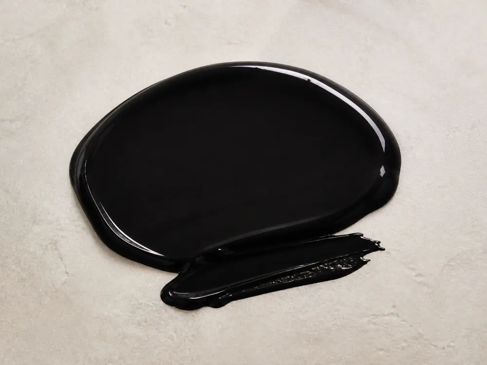 Realistic glossy Japan Black Enamel sample on a neutral mineral surface