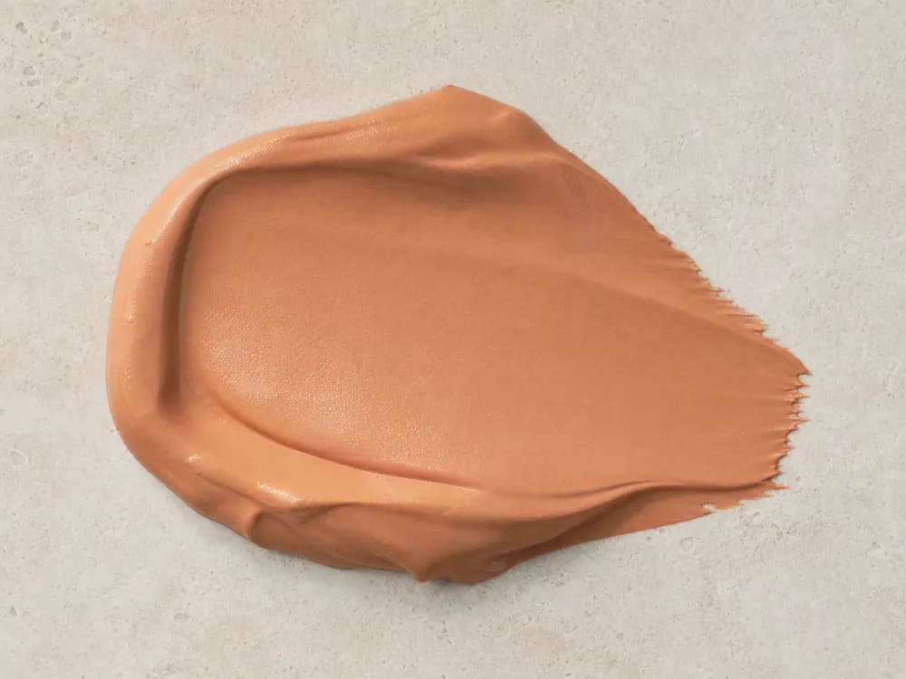 Realistic terracotta satin wall paint sample on a neutral mineral surface
