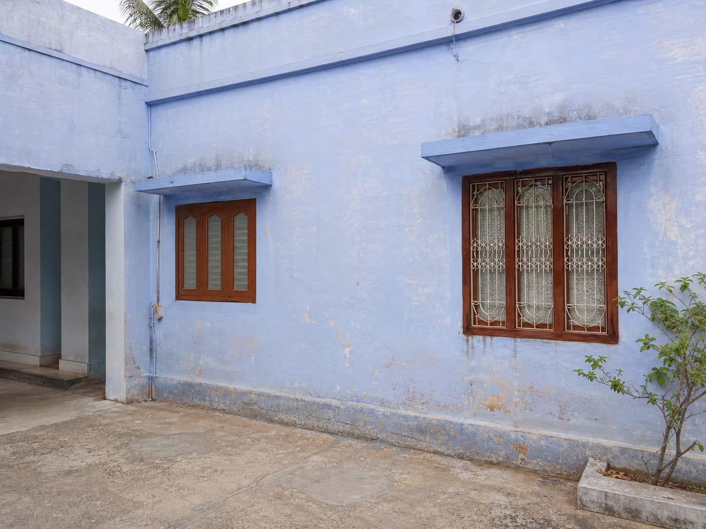 Sun-faded exterior paint on a South Indian home