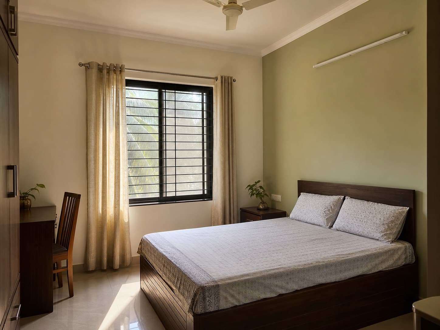 Calm Indian bedroom with softly painted walls and natural ventilation