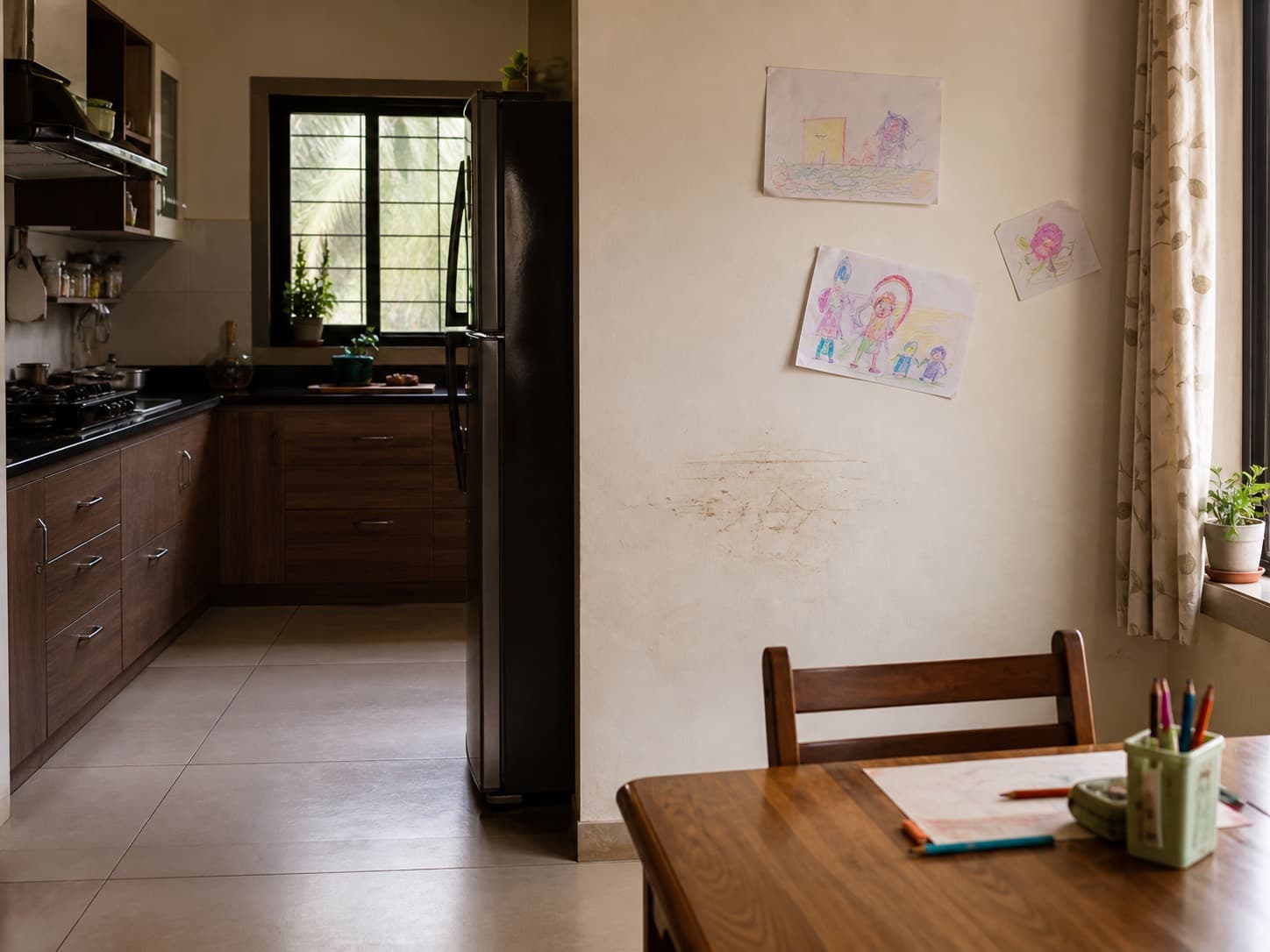 Busy Indian kitchen and family area with a painted wall needing routine cleaning