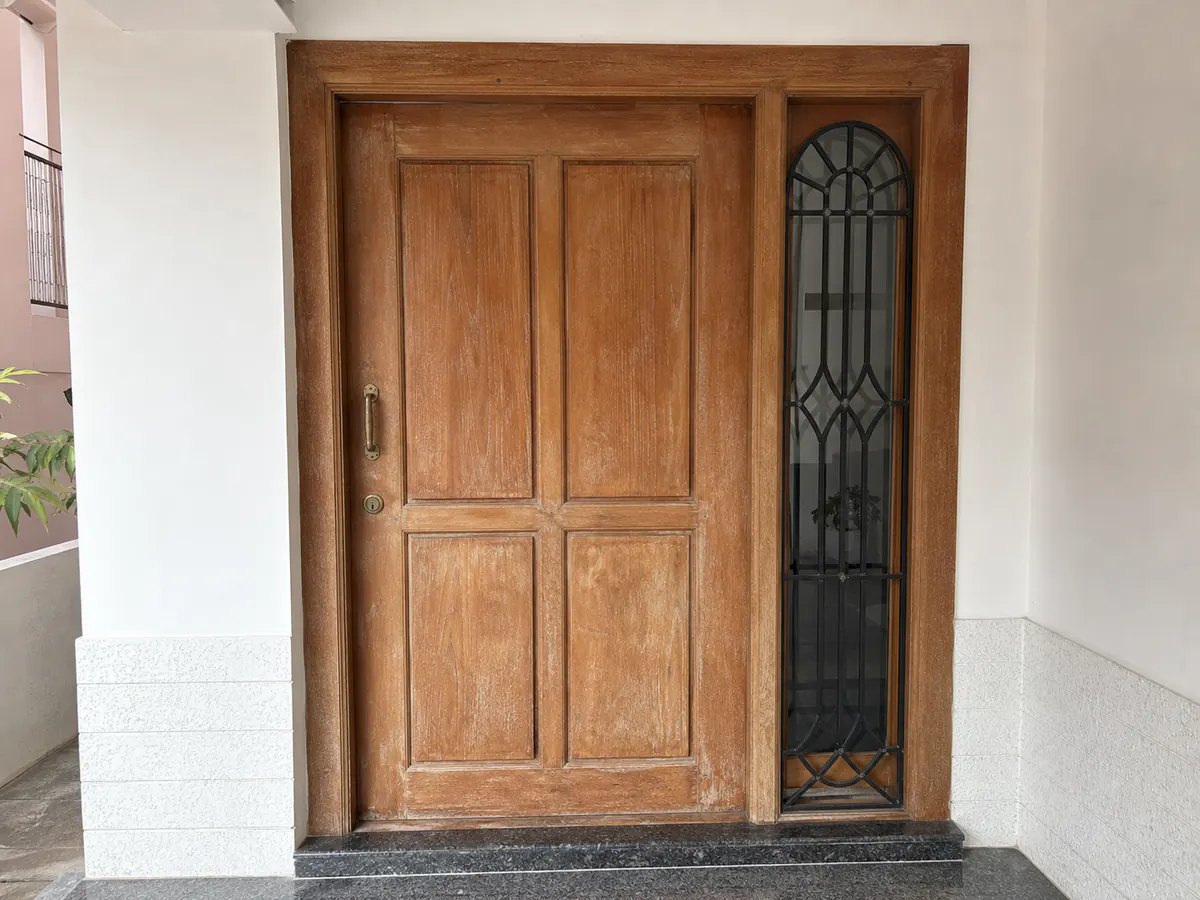 Illustrative weathered wooden front door before refinishing