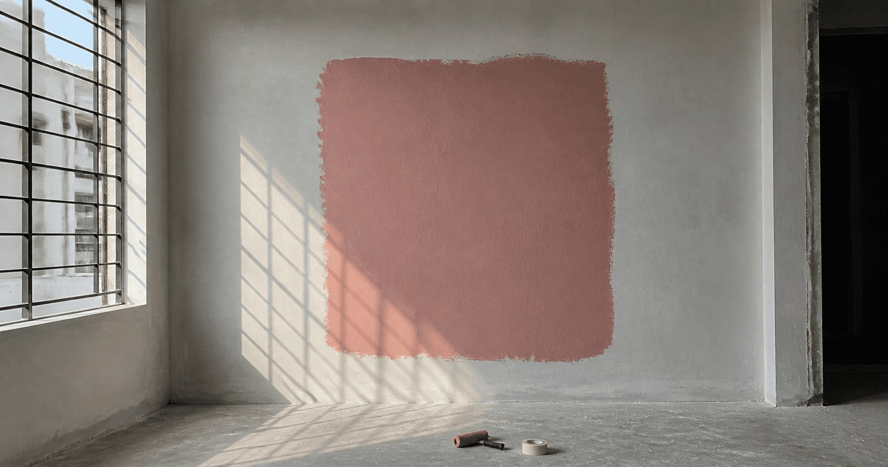 A one metre square test patch of paint on an interior wall in daylight